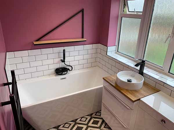 bathroom renovation with purple walls and shelving